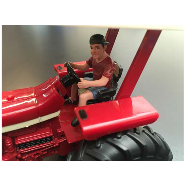 Young farmer driving tractor